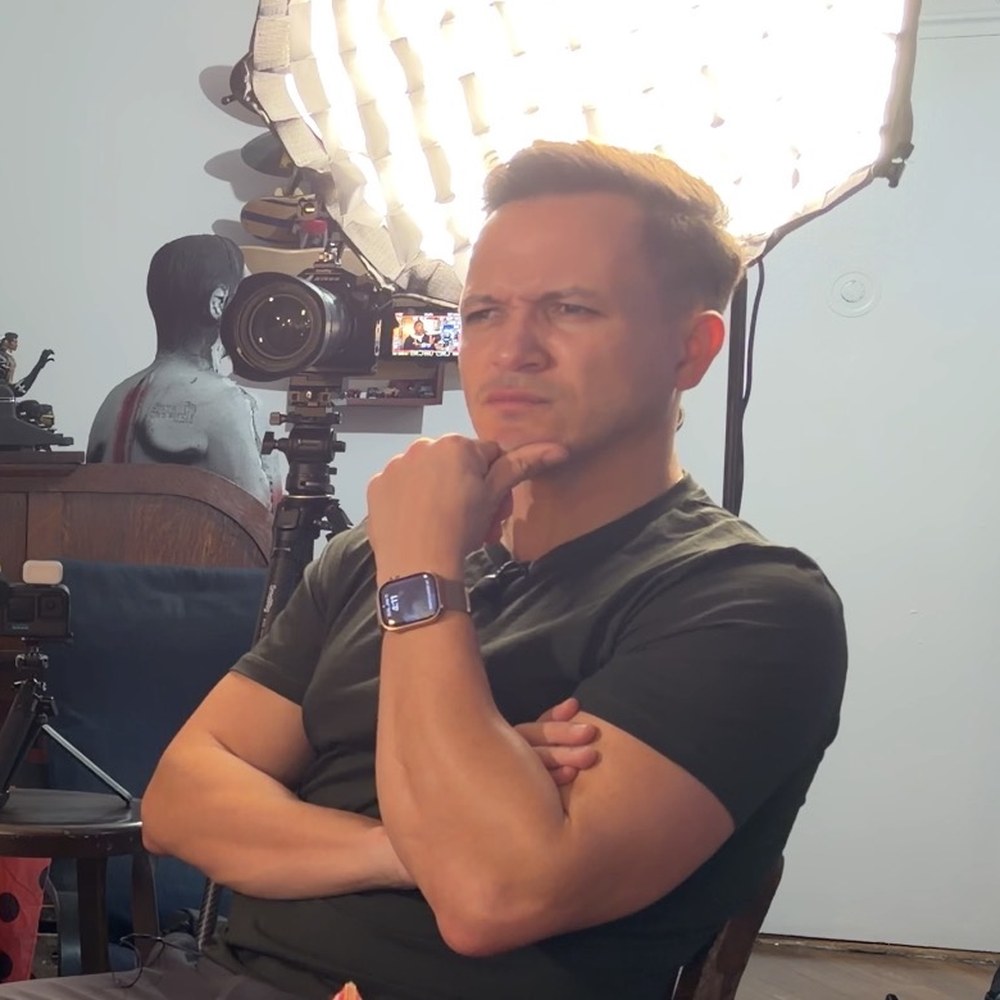 Derick Waller coaching an executive on camera during a filmed interview