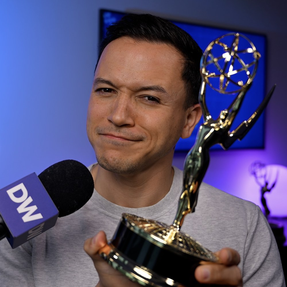 Derick Waller holding his Emmy Award
